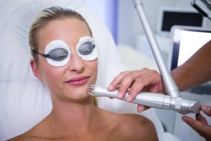 Female patient getting rf lifting procedure in a beauty saloon